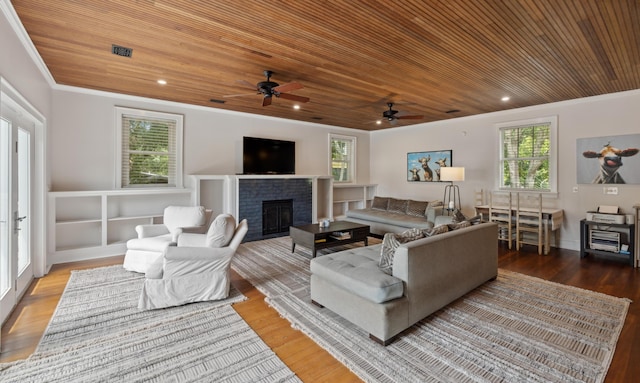 2218 Myrtle Ave, Sullivans Island, SC 29482 - living area featuring wood ceiling, a ceiling fan, wood finished floors, a fireplace, and crown molding