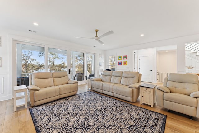 living room featuring ceiling fan and light hardwood / wood-style floors