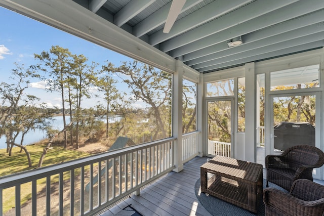 sunroom / solarium with a water view