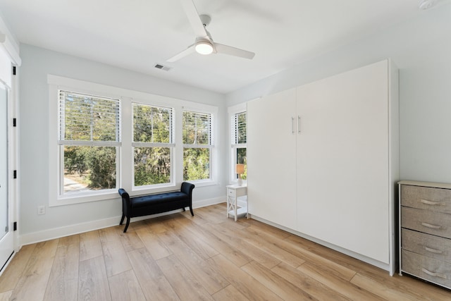 living area with ceiling fan and light hardwood / wood-style floors