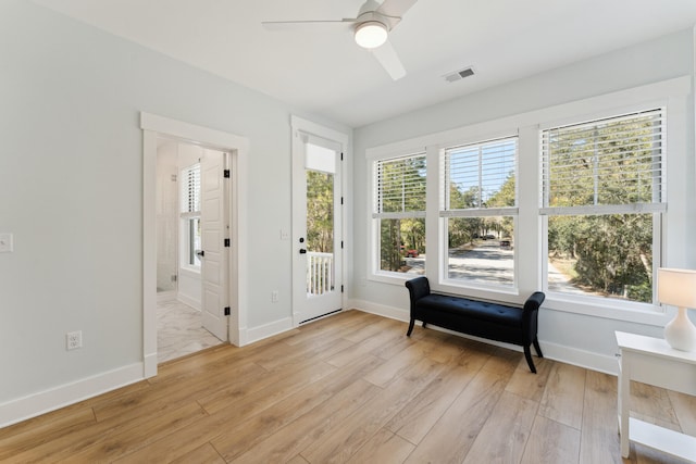 interior space with a healthy amount of sunlight, ceiling fan, and light hardwood / wood-style flooring