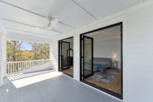 wooden deck featuring ceiling fan