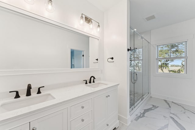 bathroom with vanity and a shower with shower door