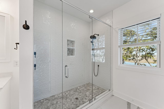 bathroom with a shower with shower door