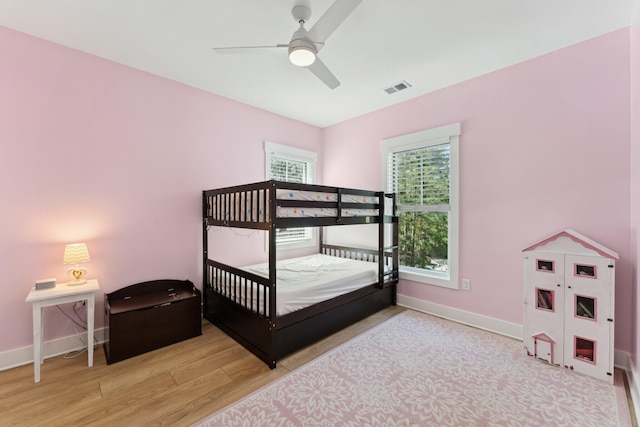 bedroom with ceiling fan and light wood-type flooring