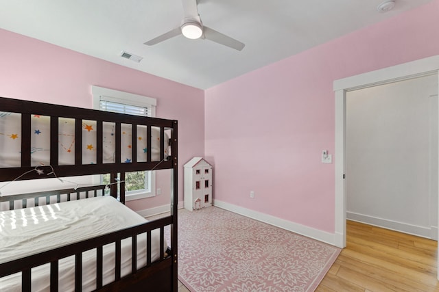 bedroom with ceiling fan and light hardwood / wood-style flooring