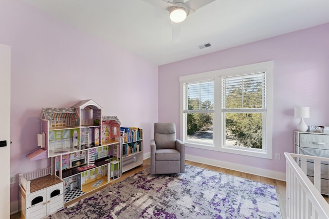 sitting room with wood-type flooring