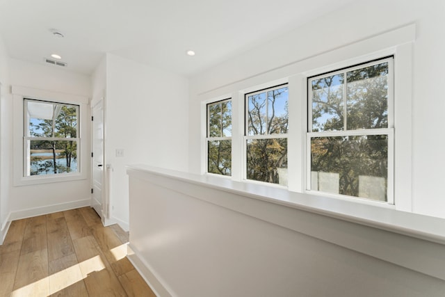 hall with hardwood / wood-style floors