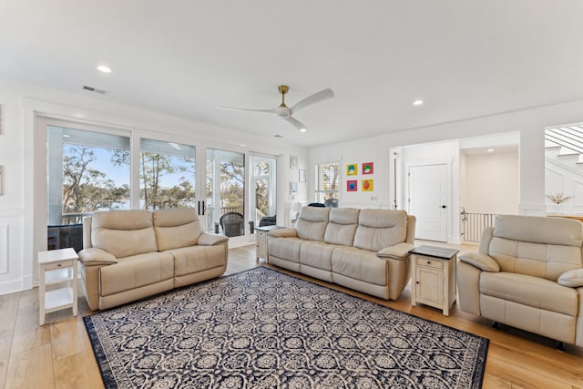 living room with ceiling fan and light wood-type flooring