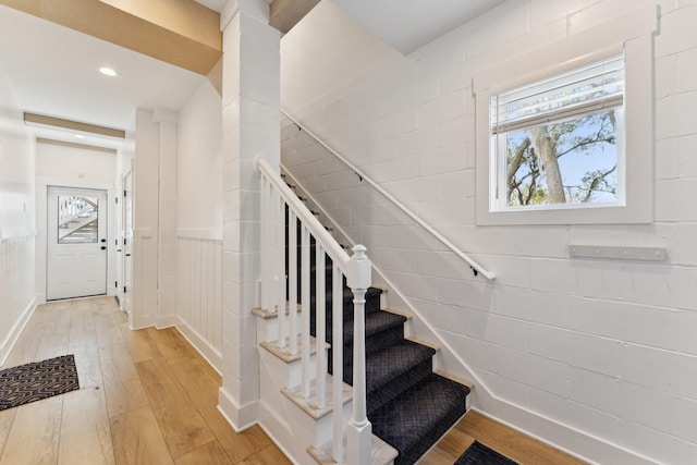 staircase with hardwood / wood-style floors and a wealth of natural light