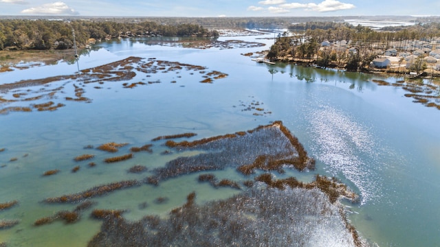 snowy aerial view with a water view