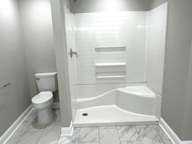 bathroom featuring walk in shower and toilet