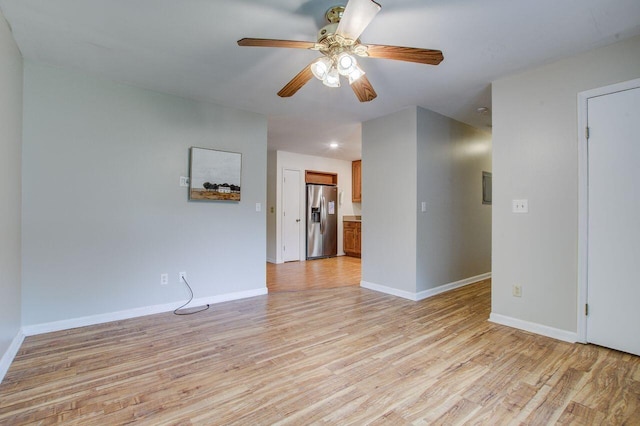 spare room featuring light wood-type flooring and ceiling fan