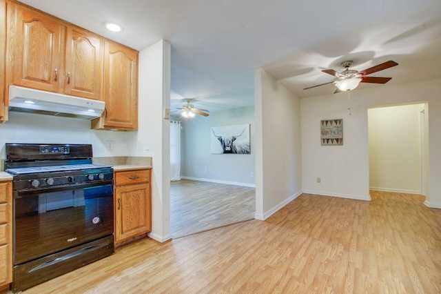 kitchen with light hardwood / wood-style floors, black gas stove, and ceiling fan