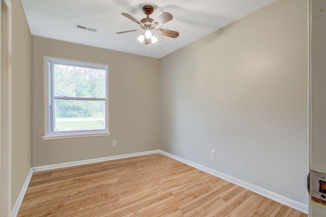 spare room featuring light wood-type flooring and ceiling fan