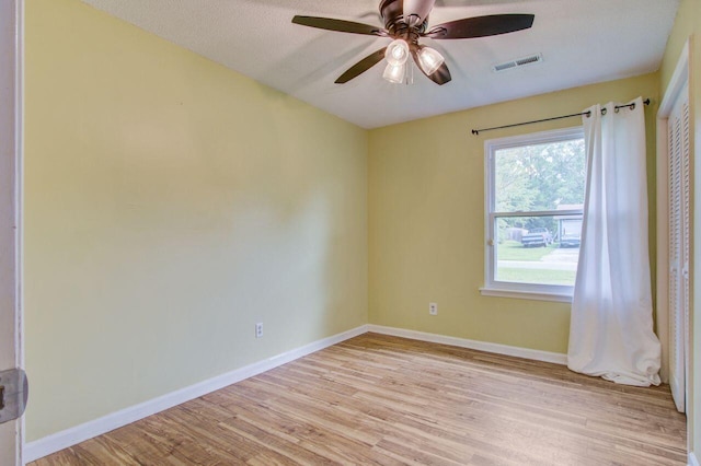 unfurnished room with light wood-type flooring and ceiling fan