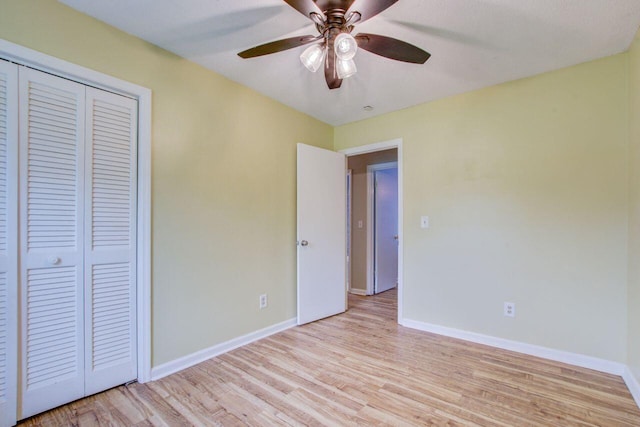 unfurnished bedroom featuring a closet, ceiling fan, and light wood-type flooring