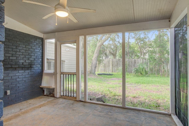 unfurnished sunroom with lofted ceiling and ceiling fan