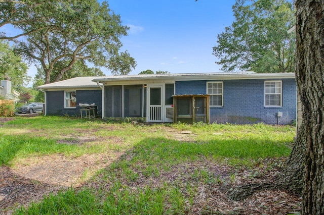 back of property with a sunroom