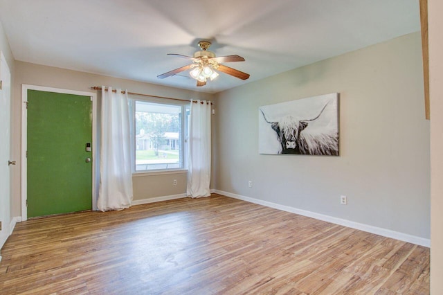 empty room with light hardwood / wood-style flooring and ceiling fan