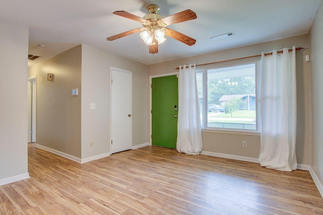 empty room featuring light wood-type flooring and ceiling fan