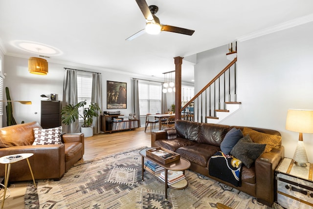 living room with ornate columns, ceiling fan, ornamental molding, and light hardwood / wood-style floors