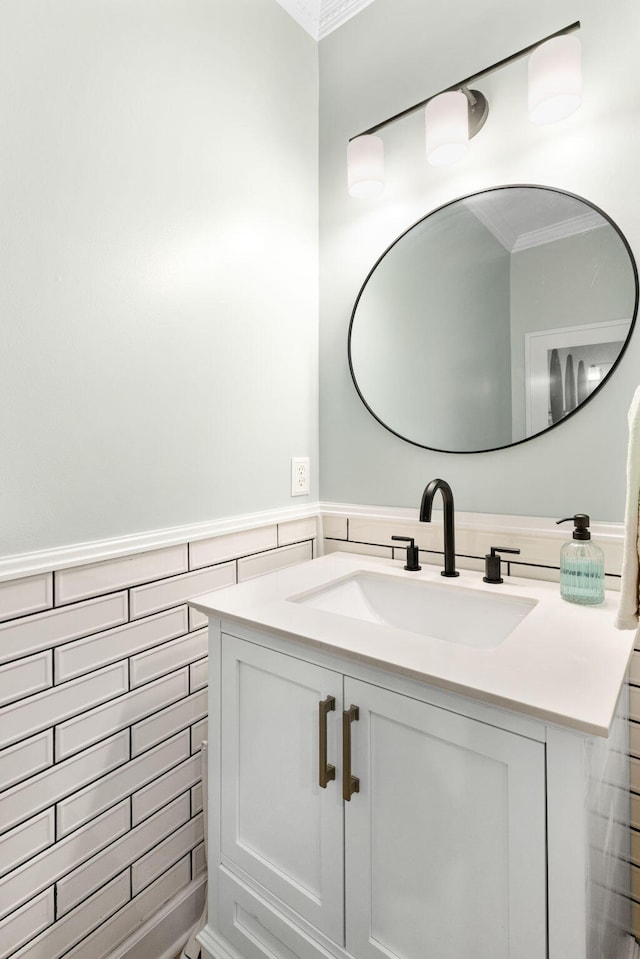 bathroom with tile walls, vanity, and crown molding