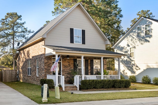 view of front of home with covered porch and a front lawn