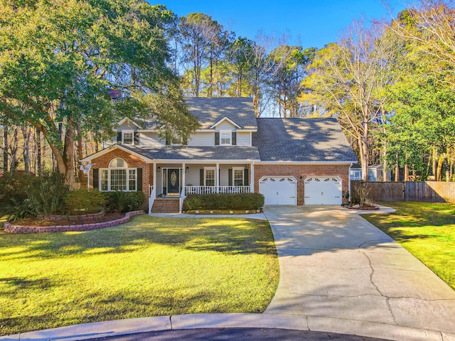 view of front of property featuring a front yard, a porch, and a garage