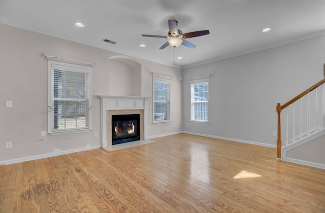 unfurnished living room with plenty of natural light, ceiling fan, and light wood-type flooring