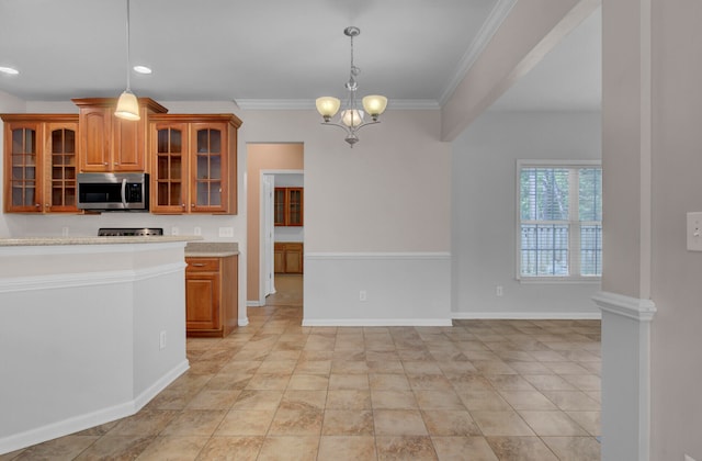 kitchen with ornamental molding, an inviting chandelier, pendant lighting, and light tile floors