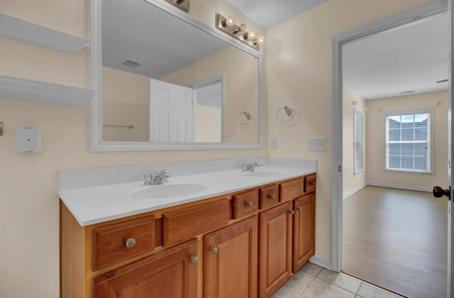 bathroom featuring tile floors, large vanity, and dual sinks