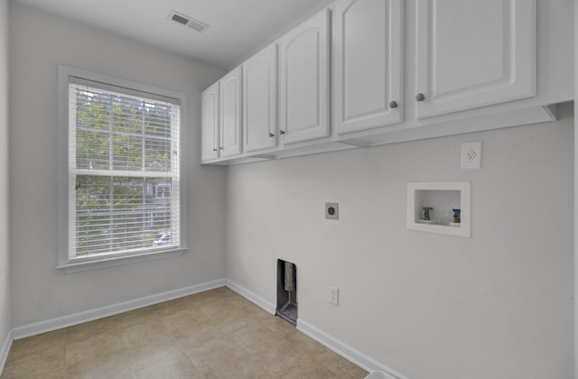 laundry room featuring cabinets, hookup for an electric dryer, light tile flooring, and washer hookup