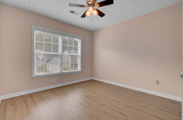 spare room featuring ceiling fan and light hardwood / wood-style flooring