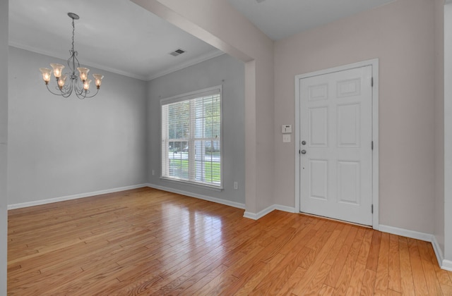 entryway with a chandelier, light hardwood / wood-style flooring, and crown molding