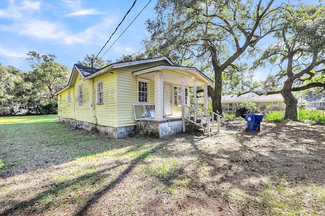 bungalow-style home with a front lawn