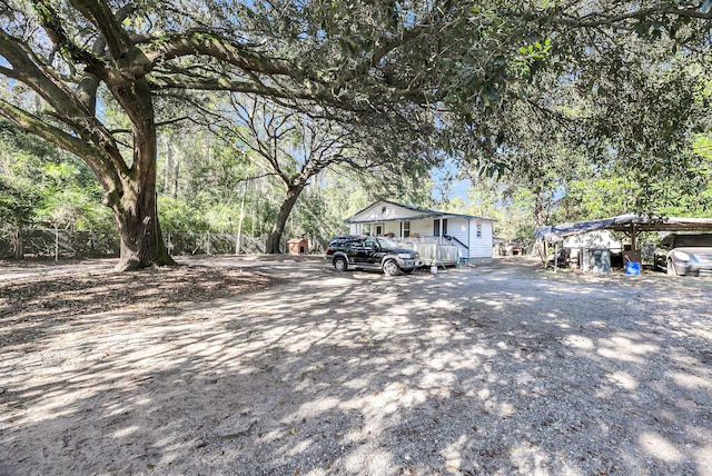 view of front of house featuring a carport and a wooden deck