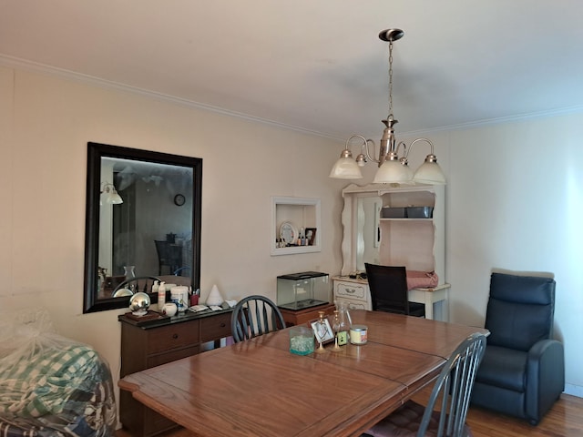 dining area with hardwood / wood-style flooring, a notable chandelier, and ornamental molding