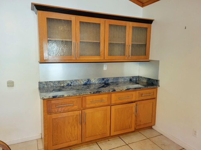 400 Murray Blvd, Summerville, SC 29483 - kitchen featuring light tile patterned floors, dark stone countertops, and crown molding