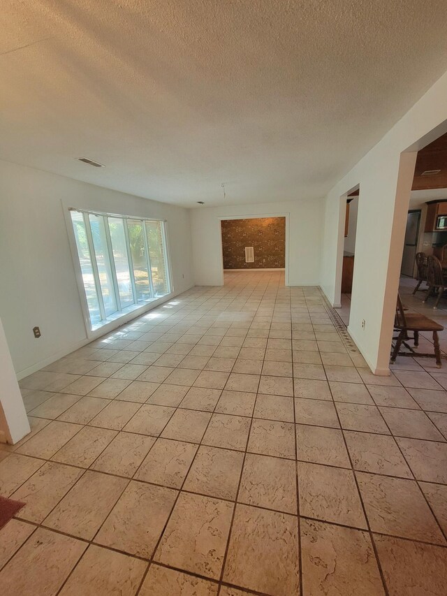 400 Murray Blvd, Summerville, SC 29483 - unfurnished living room featuring a textured ceiling and light tile patterned flooring