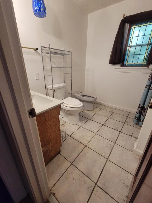 400 Murray Blvd, Summerville, SC 29483 - bathroom with a textured ceiling, tile patterned floors, vanity, toilet, and a bidet