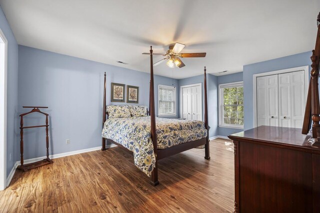 305 Whitewood Ct, Moncks Corner, SC 29461 - bedroom with baseboards, wood finished floors, and multiple closets
