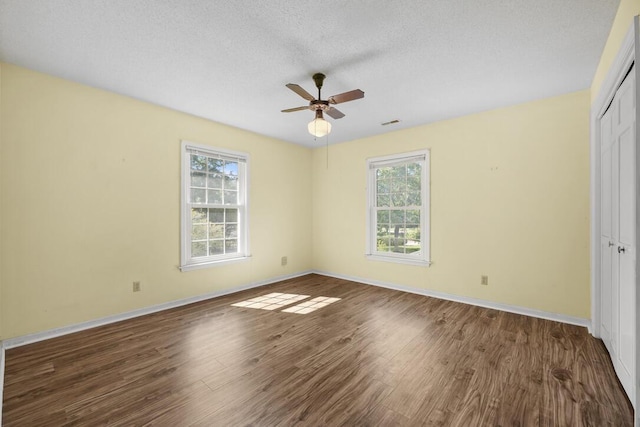305 Whitewood Ct, Moncks Corner, SC 29461 - unfurnished bedroom featuring a closet, wood finished floors, baseboards, a ceiling fan, and a textured ceiling