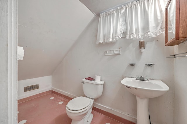 bathroom featuring toilet and vaulted ceiling