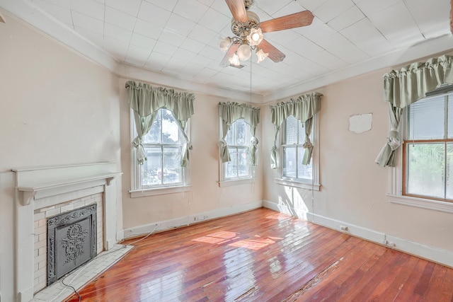 unfurnished living room with a fireplace, ornamental molding, and light hardwood / wood-style floors