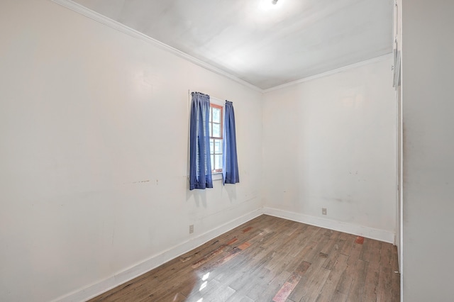 spare room with hardwood / wood-style floors and crown molding