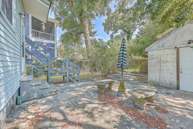 view of patio featuring a sunroom