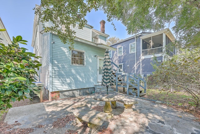 back of house with a patio and ceiling fan