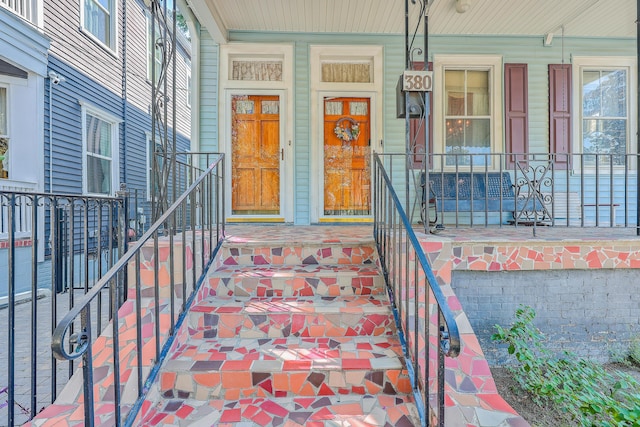 view of exterior entry featuring a porch