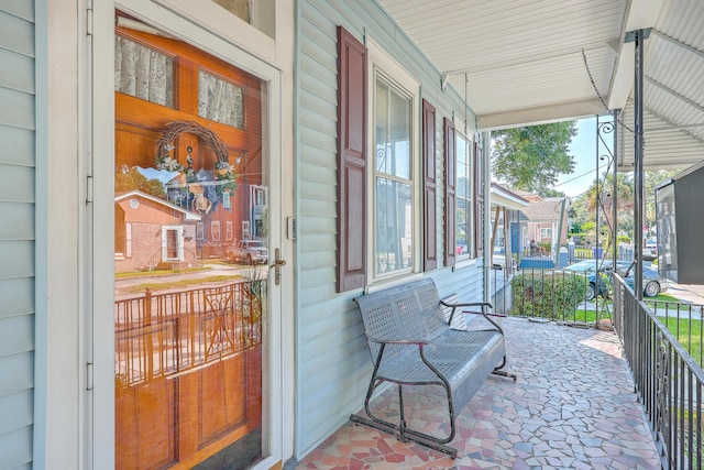 view of exterior entry featuring covered porch